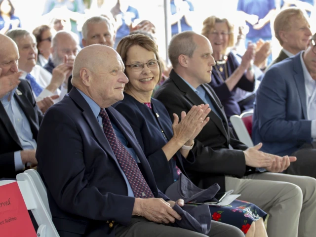 Audience members applaud during a University of Arizona ceremony celebrating the Wyant College renaming.