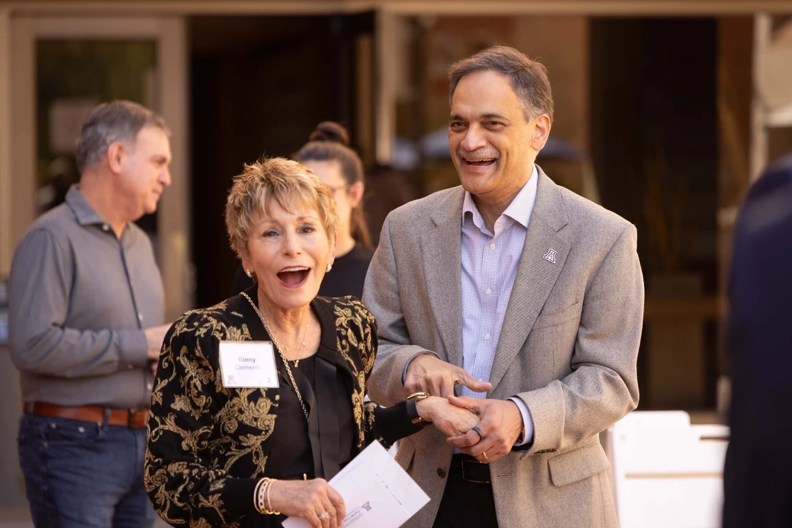 A man holding a woman's hand and laughing 