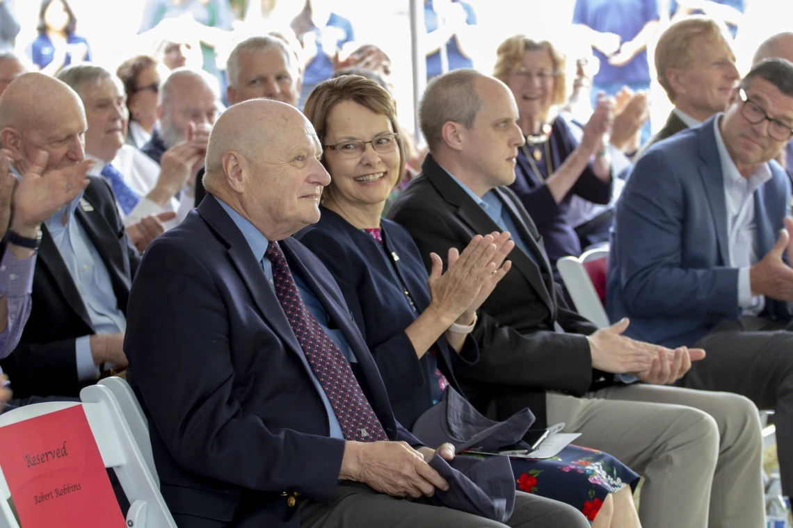 Audience members applaud during a University of Arizona ceremony celebrating the Wyant College renaming.