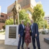 A photograph of Ken and Donna Coit with Rick G. Schnellmann standing in front of the gold Ken Coit statue 