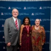 Three people standing in front of a "University of Arizona College of Medicine" backdrop